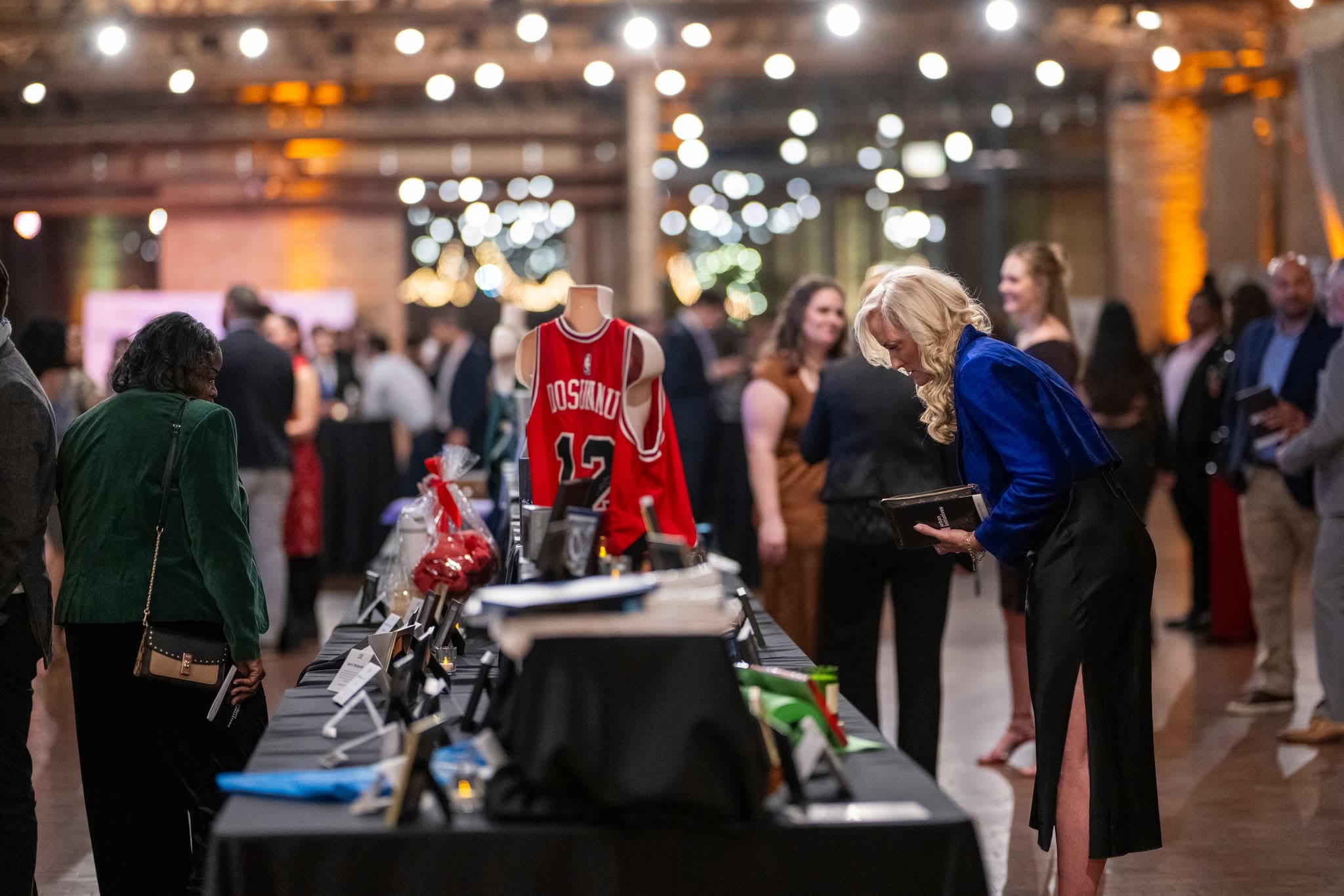 Woman looking at a silent auction item