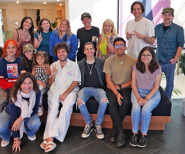 Music industry professionals pose for a photo with teen and young adult cancer survivors