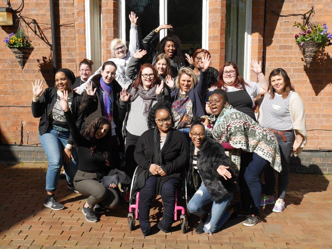 A photo of a group of Advisory Panel members who are waving at the camera and smiling