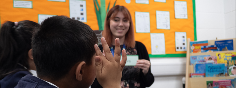 tutor smiling at two pupils
