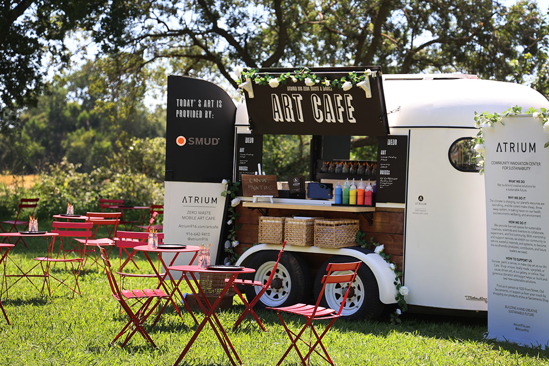 Image of Atrium-916 Zero-Waste Mobile Art Cafe open with tables and chairs on grassy background