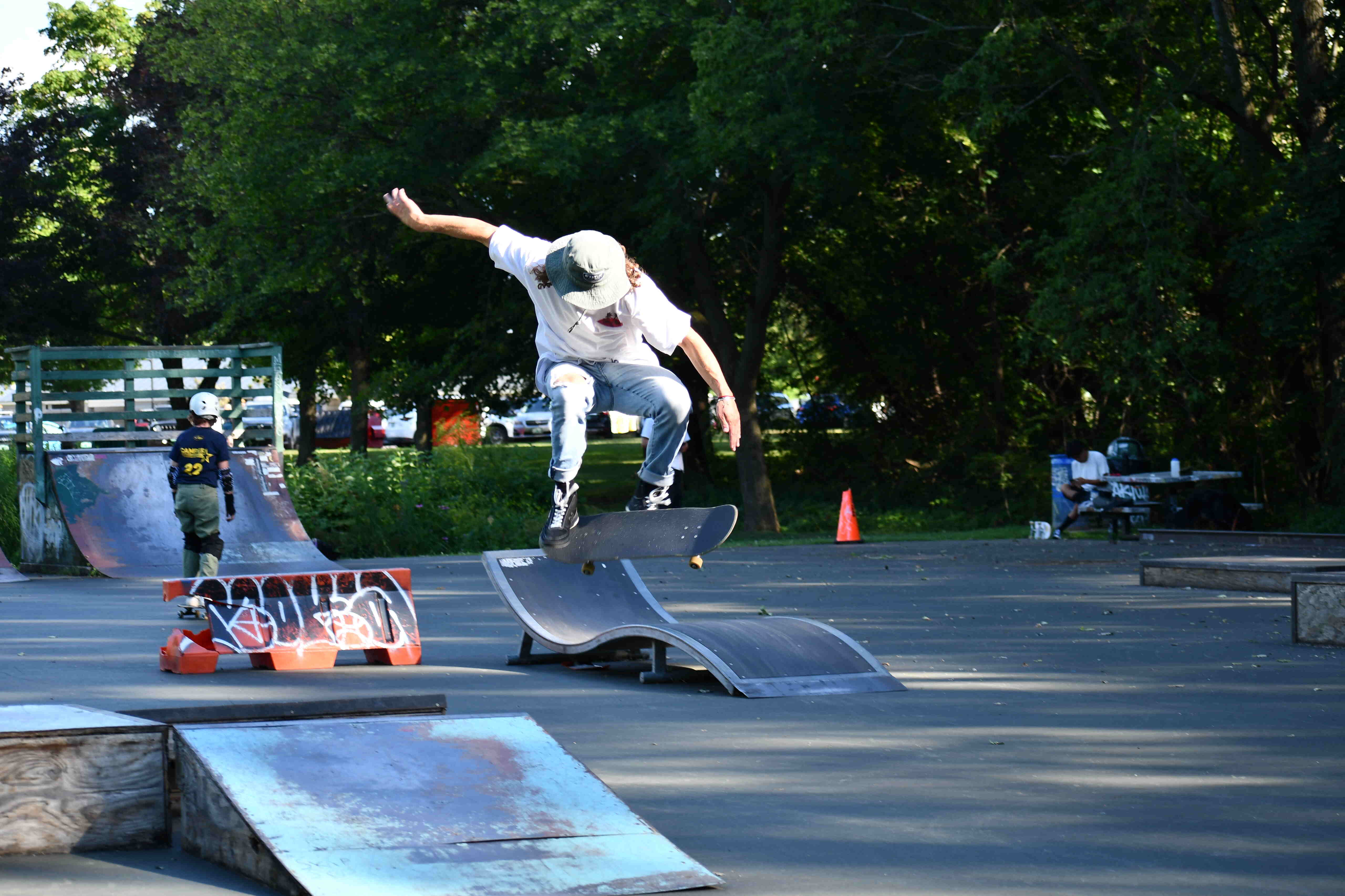 An adult shows a skateboard trick