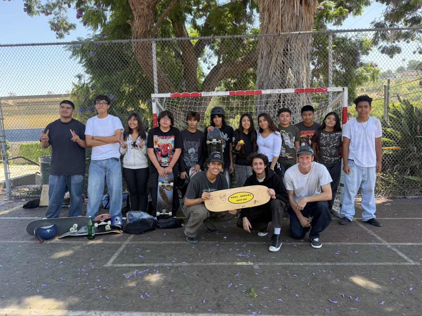 A group of youth and adults pose after a rad day of skating
